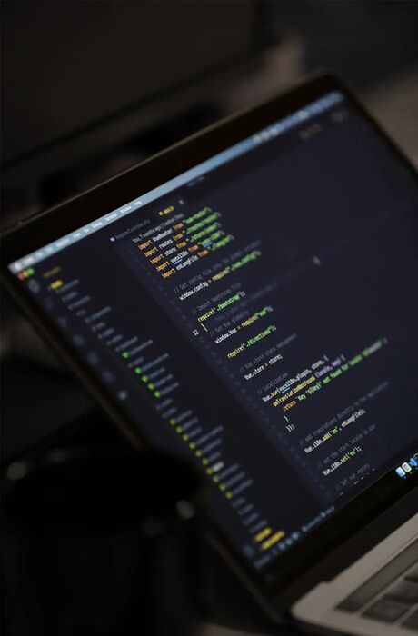 Code is structurally displayed on a laptop screen.