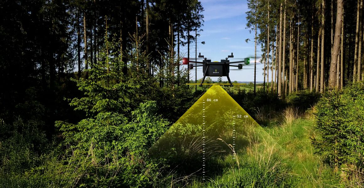 A drone flies through a forest clearing. Next to the magnetic field analysis, the pipeline visually scans the ground surface to identify surface risks along the right-of-way, such as ground movement or encroachement.