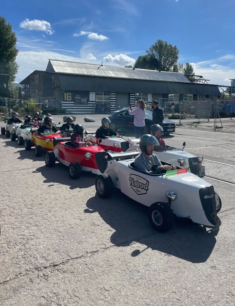 Employees drive soapbox cars at a team event through Berlin.
