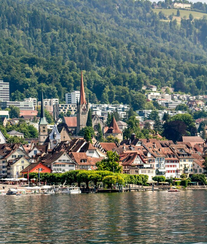 view from a lake to a small town in switzerland