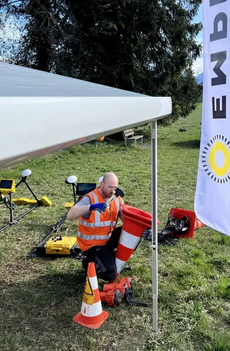 An EMPIT field operator grills at a barbecue.
