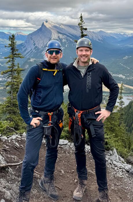 Mark Glinka and Alexander Kroll op a mountain in climbing gear.